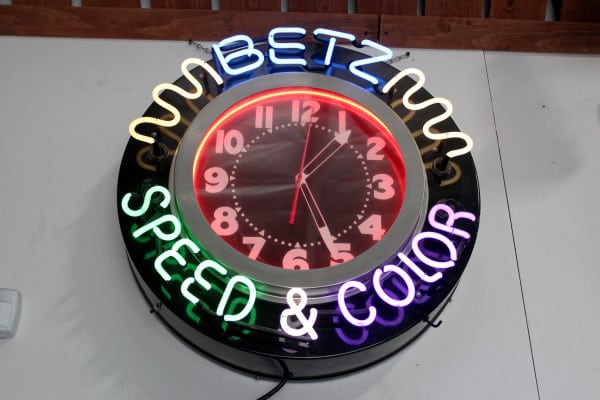 Stan Betz displays a neon clock from his business, Betz Speed and Color. He sold the paint shop to Sherwin Williams in 1993.
